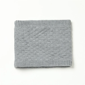 Detail view of grey knit neck warmer featuring a textured checkered weave pattern