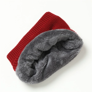 Close-up of red knit neck warmer featuring thick grey faux fur lining for winter warmth