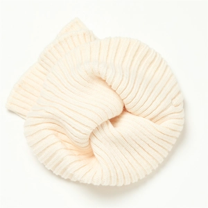 Close-up of cream ribbed knit texture on a soft winter neck warmer scarf