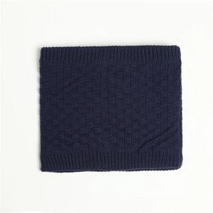 Close-up of deep blue knitted neck warmer featuring checkered texture and ribbed edges
