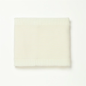 Detailed close-up of cream knit snood scarf texture with soft ribbed edges and fine weave