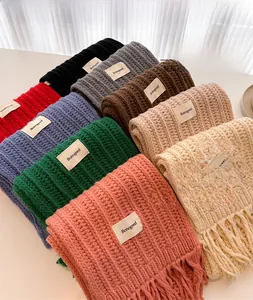 Detailed knit texture and fringe on thick wool scarves in multiple stylish colors