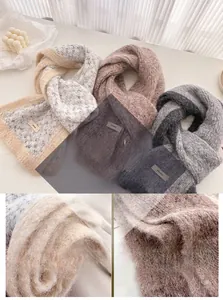 Close-up of soft thick plush wool scarf with contrast stitching and woven label