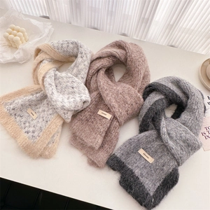 Close-up of soft knit wool scarves with color-block design and premium woven labels