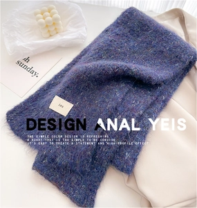 Detail of wool blend knit scarf with fluffy texture and minimalist rectangle label