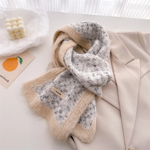 Close-up of knit scarf texture with BONOGEED leather label and plush fur trim detail