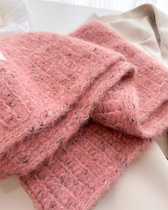 Detailed texture of dusty pink wool blend knit scarf with soft fluffy mohair finish
