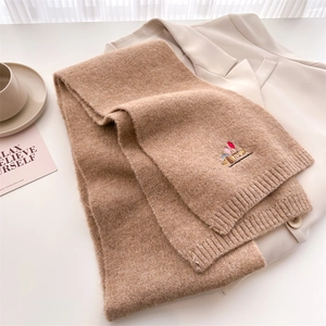 Detail of khaki knitted scarf featuring a cute puppy embroidery and ribbed texture