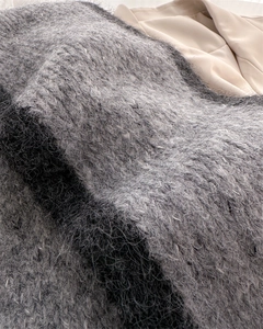 Macro shot of striped mohair scarf showing thick grey and black fuzzy knit texture