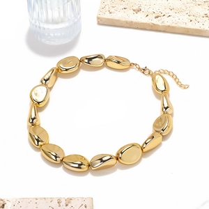 Vintage gold irregular CCB bead necklace with polished metallic finish on white background