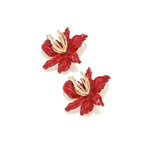 Stereoscopic red enamel flower earrings with golden metal pistils on white background