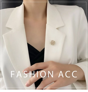 Exquisite rotating flower brooch with white crystals on a white suit lapel