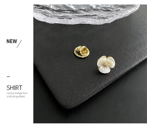 Detail of flower brooch showing front shell petals and back butterfly clutch clasp