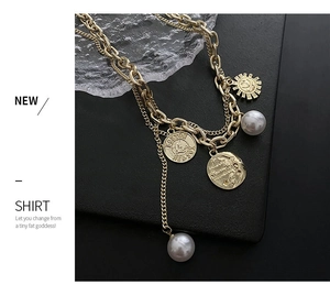 Macro detail of vintage gold layered necklace with coin charms and faux pearls