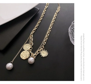 Detail of layered gold coin necklace featuring vintage portraits and iridescent pearls