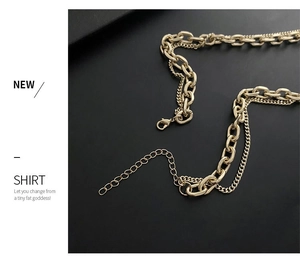 Detail of gold double-layer chain necklace showing lobster clasp and extender chain links