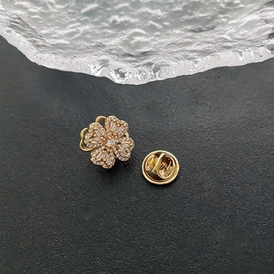 Elegant rotating flower brooch with sparkling cubic zirconia on a minimalist grey background