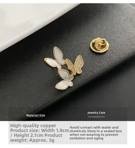 Macro detail of butterfly brooch showing shell inlay and zircon accents on copper