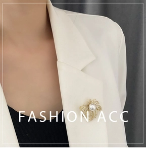 Detail of luxury pearl brooch with pavé rhinestones on white suit blazer lapel