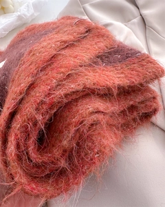 Close-up of thick knit wool scarf showing soft mohair texture in vibrant color block pattern