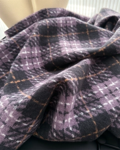 Close-up of thick plaid cashmere scarf in purple and black with yellow detail