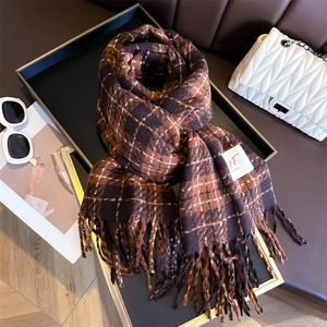 Classic brown plaid cashmere-like scarf with tassels on a stylish display tray