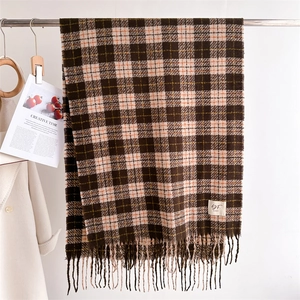 Detailed close-up of plaid cashmere-feel scarf with fringe and vintage brand label