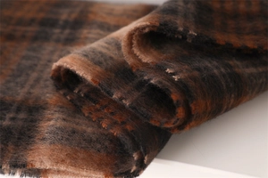 Close-up of thick plaid mohair scarf with fluffy texture in brown and black tones