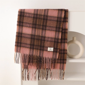 Detail of soft plaid scarf showing fringed edges and woven cashmere-like texture