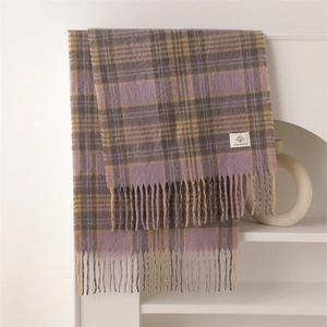 Detail of plaid tassel scarf showing purple and yellow check pattern and brand label
