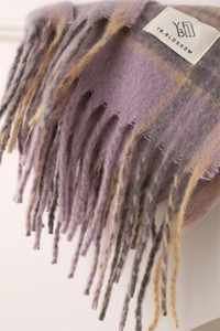 Close-up of purple and yellow plaid scarf with soft fringe and YB.BLOSSOM brand label