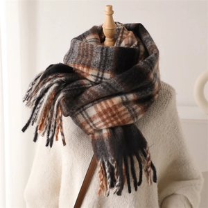 Detail of vintage plaid scarf featuring long tassels and soft warm cashmere texture