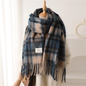 Detailed view of checkered cashmere-feel scarf with elegant fringes on display