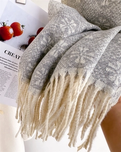 Detailed texture of jacquard knit shawl with fringe edge and geometric pattern