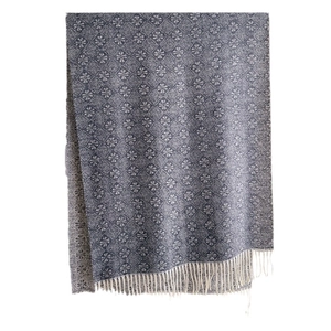 Winter jacquard knit scarf with navy blue floral patterns and handmade tassel edges