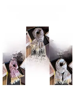Detail of floral cashmere-like shawls with tassels in brown, pink, and grey options