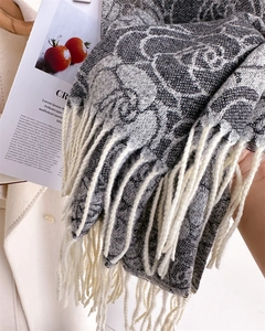 Close-up of floral jacquard knit scarf with elegant fringe and rose pattern