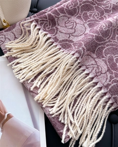 Detail of rose jacquard knit scarf in mauve with soft fringe and fine texture