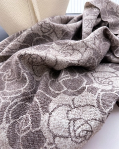 Close-up of elegant floral jacquard knit scarf with premium cashmere feel texture
