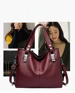 Détails du sac à main en cuir grainé bordeaux avec double poignée et rivets argentés
