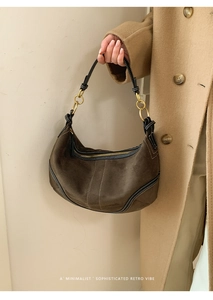 Détail du sac hobo en daim marron foncé avec surpiqûres et accessoires dorés