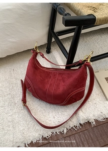 Gros plan sur le sac hobo en daim avec coutures contrastées et détails dorés
