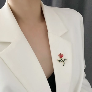 Exquisite red rose enamel brooch with gold edges on a white suit lapel for elegant styling