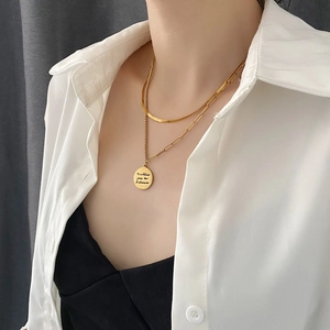 Double-layered gold necklace with snake chain and round letter pendant for women