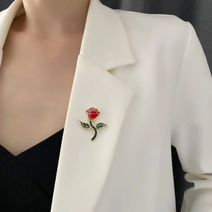 Artistic red rose enamel brooch with gold stem on white blazer for vintage style