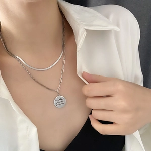 Double-layered silver necklace with snake chain and engraved coin pendant for women