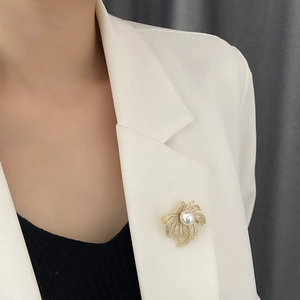 Luxurious sunburst pearl brooch with micro-set zircons pinned on a white blazer lapel