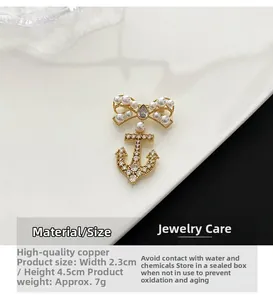 Macro shot of gold anchor brooch with pearl bow and cubic zirconia detailing