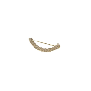 Broche sourire dorée avec cristaux baguette pour accentuer les costumes et gilets de luxe