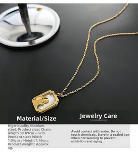 Macro detail of gold titanium necklace featuring a white shell rabbit pendant with measurements
